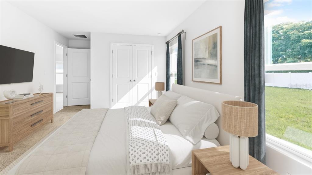 This virtually staged bedroom features a bed, dresser, and a window overlooking a grassy yard — 5168 SCHUBERT TRAIL, NORTH PORT, FL