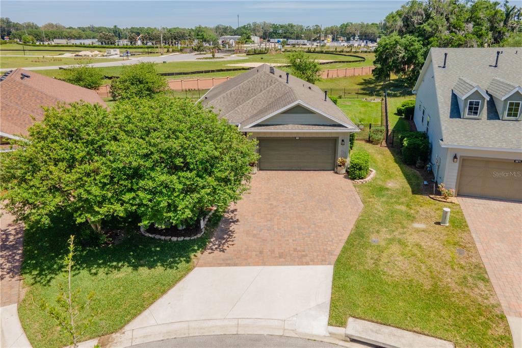An aerial view shows a single-story house with a paved driveway and a large tree — 3881 NW 46TH TERRACE, OCALA, FL