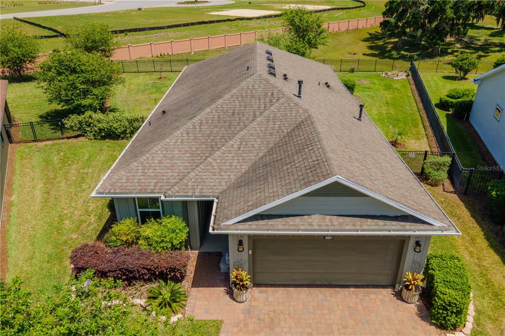 An aerial view shows the roof and front exterior of a house with a garage — 3881 NW 46TH TERRACE, OCALA, FL