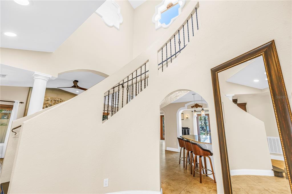 A living room features a large entertainment center, a stone fireplace, and two leather sofas — 3945 POINSETTIA DRIVE, ST PETE BEACH, FL