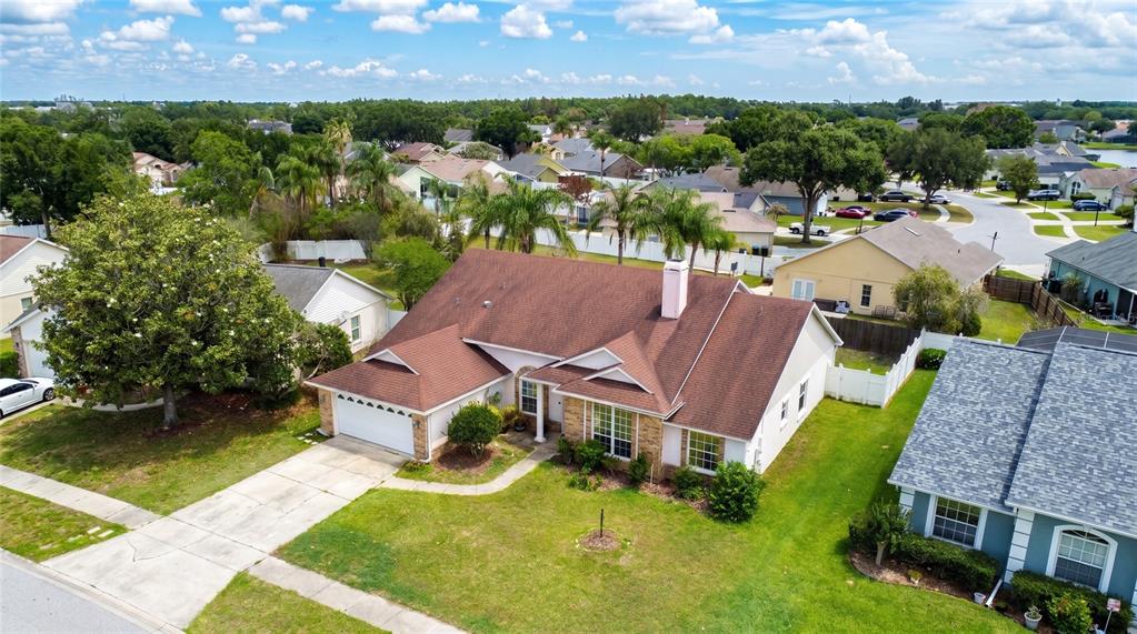 An aerial view shows a single-story house with a brown roof and a white garage — 2003 TIPTREE CIRCLE, ORLANDO, FL