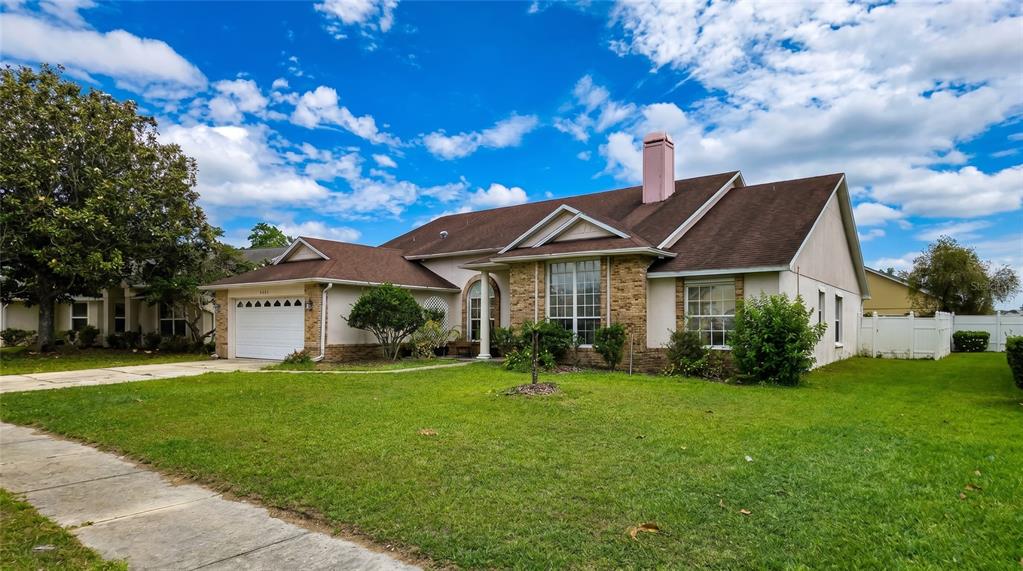 A single-story house with a brick facade, a white garage, and a pink chimney — 2003 TIPTREE CIRCLE, ORLANDO, FL