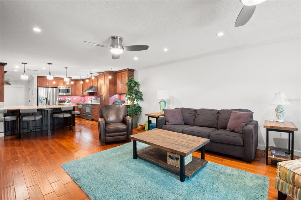 A wooden deck leads to a house entrance with blue siding and a small bench — 12 MARINER DRIVE UNIT 12, TARPON SPRINGS, FL