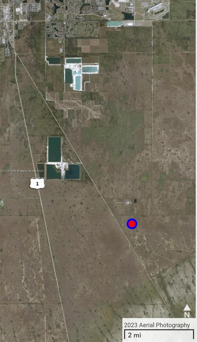 This is an aerial map showing a rural landscape with water reservoirs and a marked location — UNINCORPORATED, Homestead FL 33035, HOMESTEAD, FL