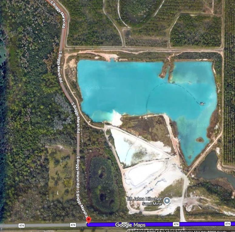 This is a satellite map view showing a large sand mine with a turquoise pond — CR 474 ROAD, CLERMONT, FL