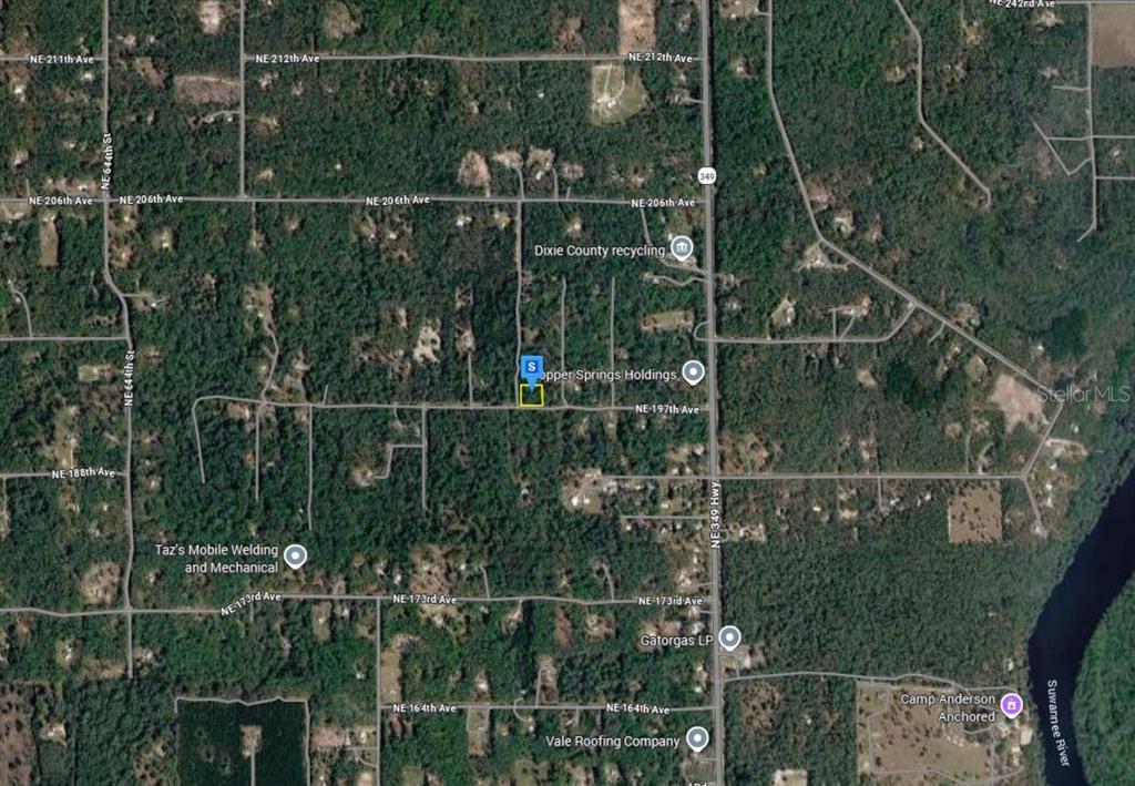 An aerial map view showing a highlighted property lot surrounded by wooded land and roads — 11 NE 717TH ST, OLD TOWN, FL