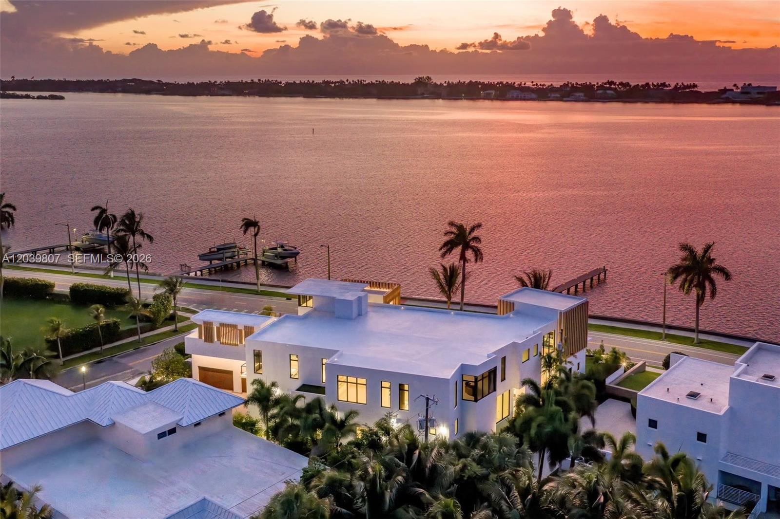 An aerial view shows a modern white house with a flat roof near the water — 6315 S Flagler Dr, West Palm Beach FL 33405, WEST PALM BEACH, FL