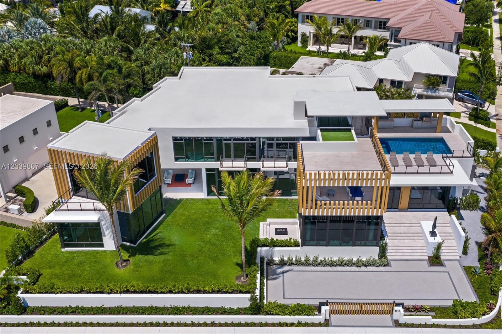 An aerial view of a modern two-story house with a pool, lawn, and wooden accents — 6315 S Flagler Dr, West Palm Beach FL 33405, WEST PALM BEACH, FL