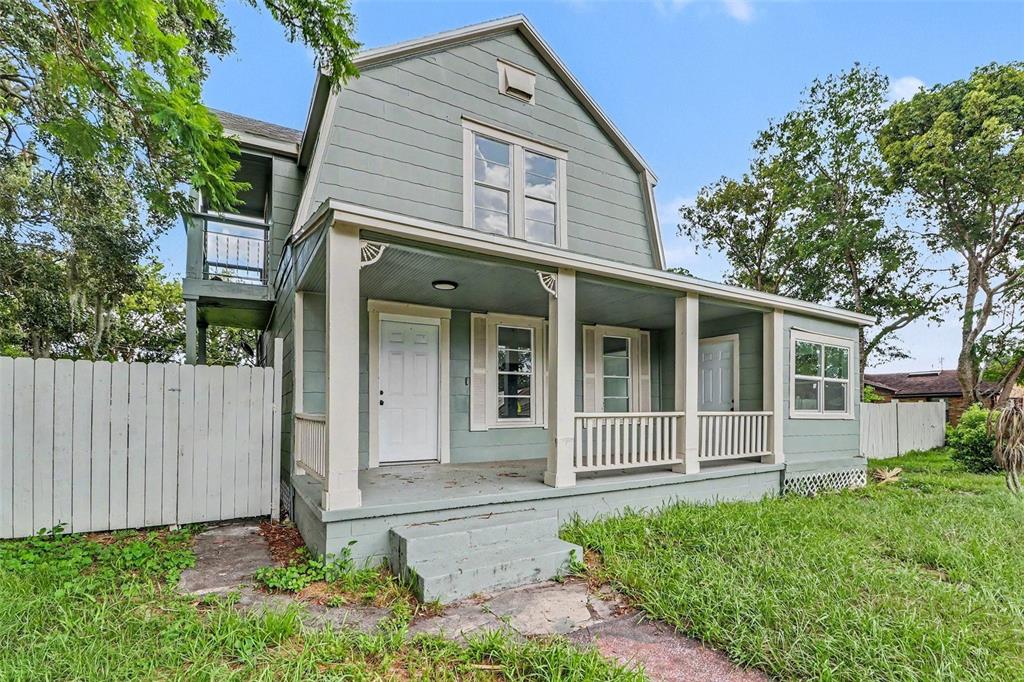A two-story house with light green siding and a covered front porch — 1515 INDIANA AVENUE, ST CLOUD, FL