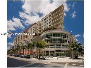 A multi-story residential building with a curved glass facade and palm trees on a street — 3250 NE 1st Ave # 303, Miami FL 33137, MIAMI, FL