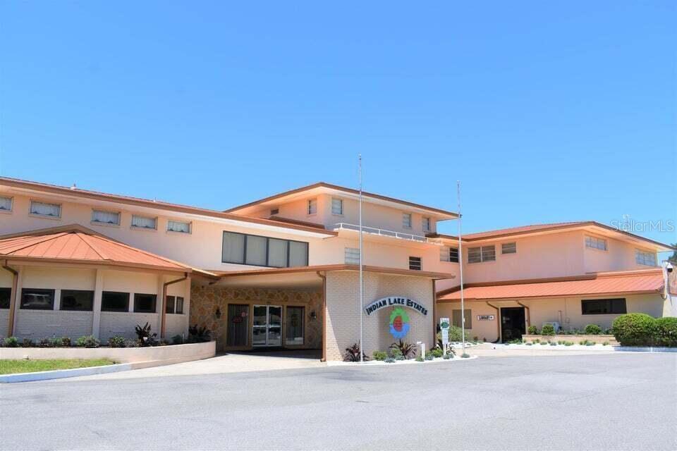 A low-rise, multi-level building with a tan exterior and a prominent Indian Lake Estates sign — TBD AZALEA DRIVE, INDIAN LAKE ESTATES, FL