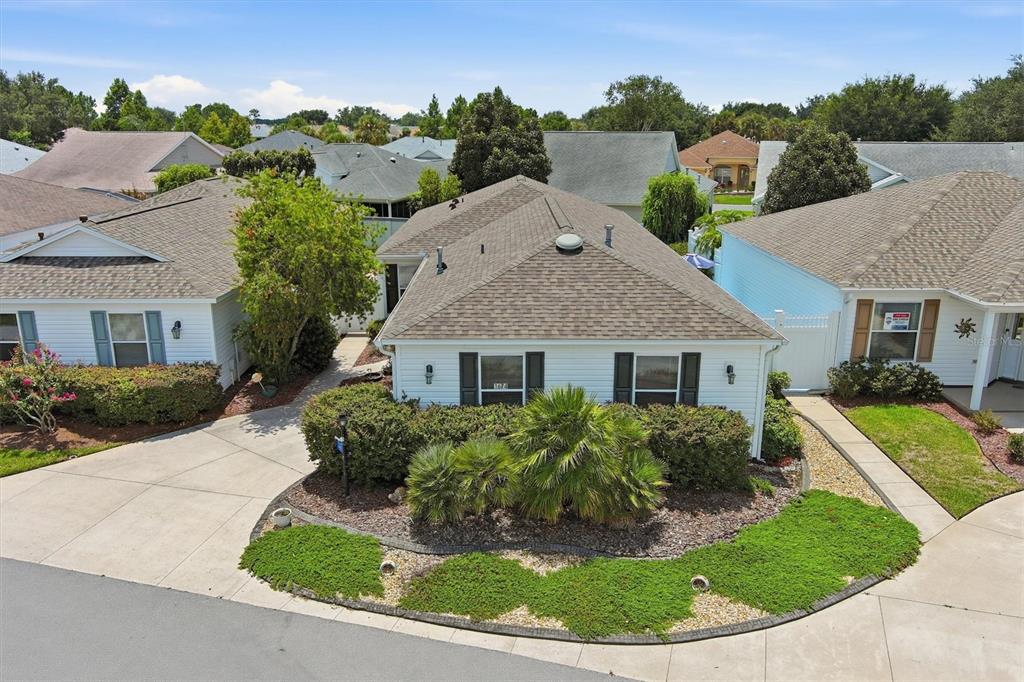 An aerial view shows a single-story house with a brown roof and white siding — 1674 GOVAN PLACE, THE VILLAGES, FL