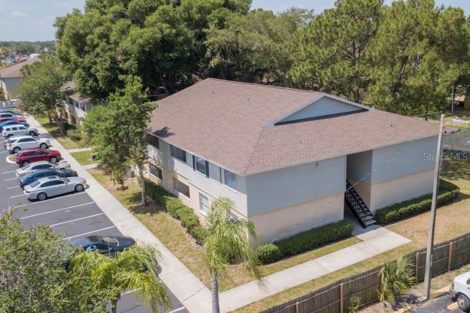 An aerial view of a two-story apartment building with a parking lot and trees — 237 RED MAPLE PLACE, BRANDON, FL
