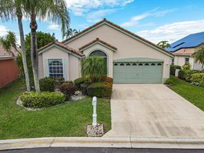 A single-story house with a beige exterior, a green garage door, and a concrete driveway — 7791 Great Glen Circle, Delray Beach FL 33446, DELRAY BEACH, FL