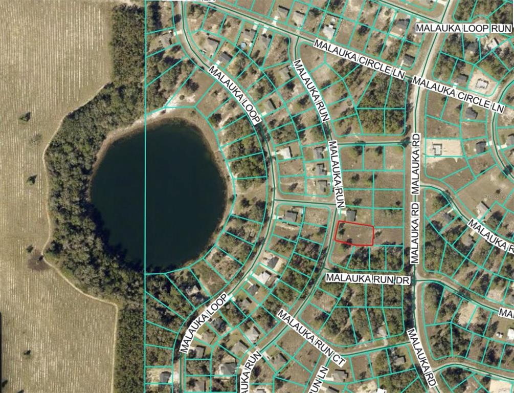 This is a satellite map showing a residential neighborhood surrounding a circular lake — LOT 5 SE MALAUKA RUN, OCKLAWAHA, FL