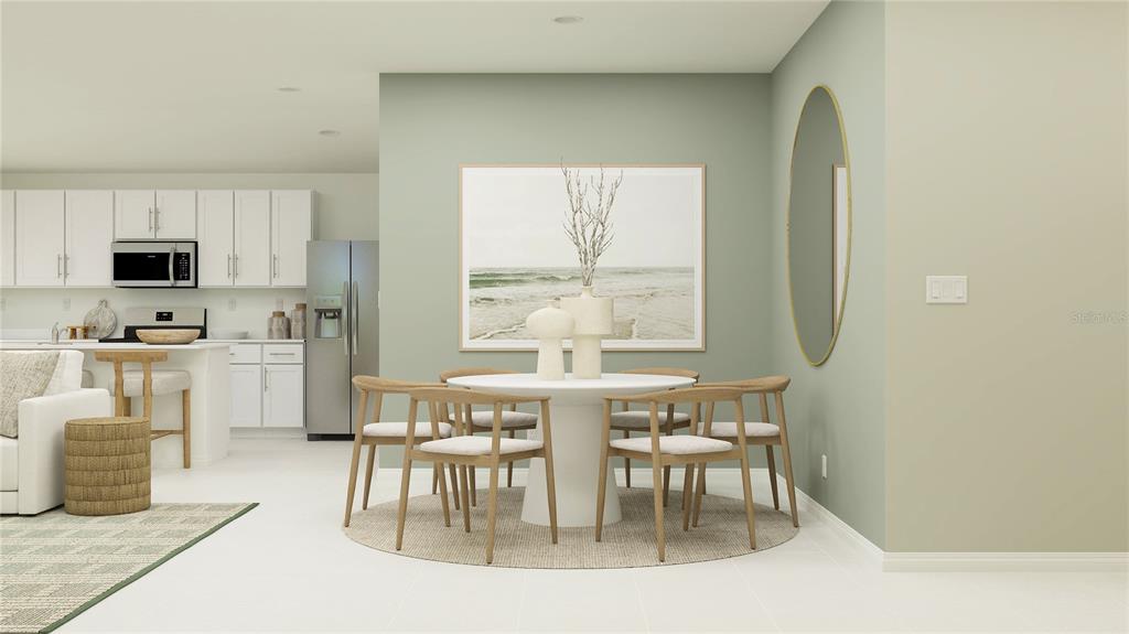 This rendering shows a dining area with a round table, chairs, and wall art — 5940 YELLOW HORNBILL AVENUE, WIMAUMA, FL
