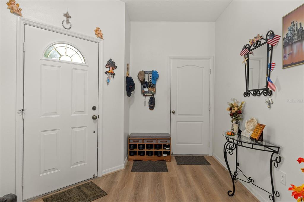 An entryway features light wood flooring, a white front door, a shoe rack, and a console — 6531 W CANNONDALE DRIVE, CRYSTAL RIVER, FL
