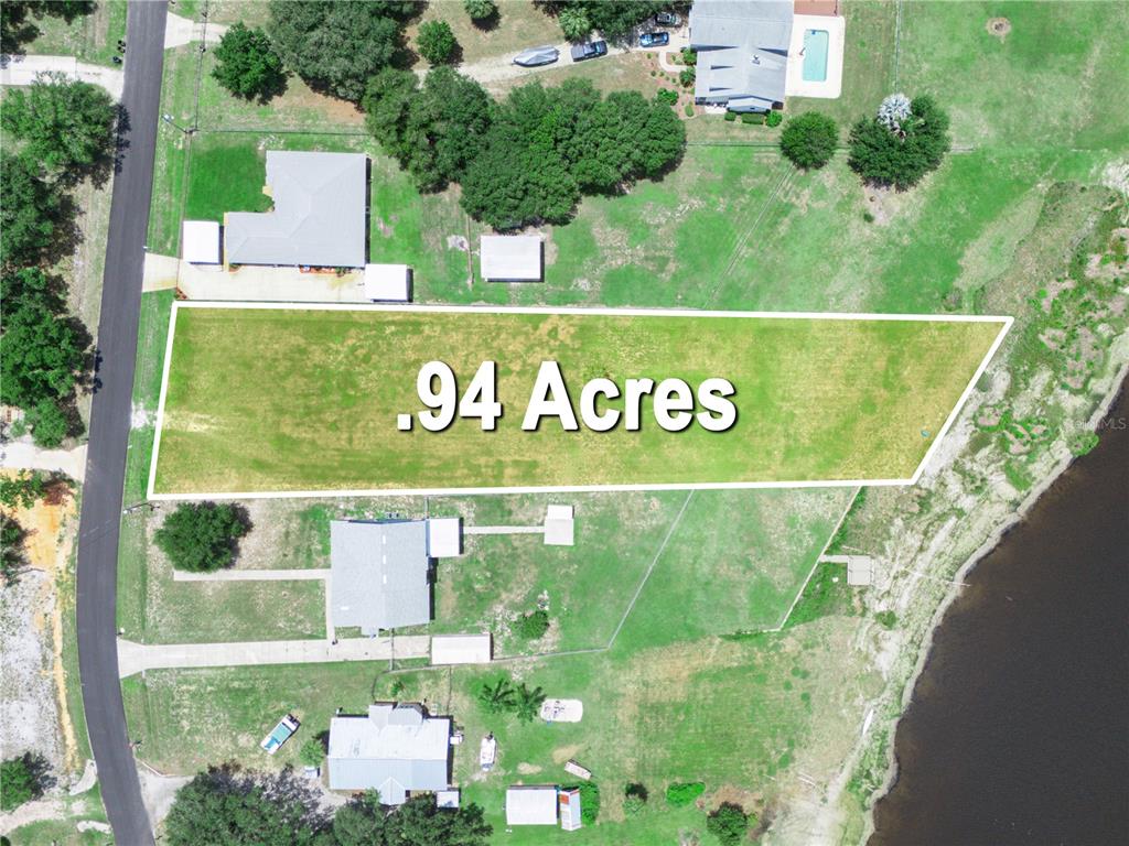 This aerial view shows a rectangular plot of land highlighted as .94 acres — 860 KEEN ROAD, FROSTPROOF, FL