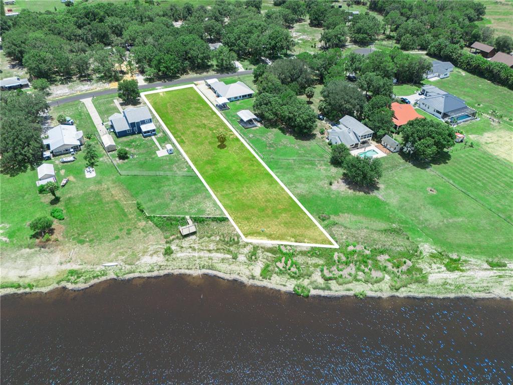 An aerial view shows a rectangular waterfront lot with a small wooden dock — 860 KEEN ROAD, FROSTPROOF, FL