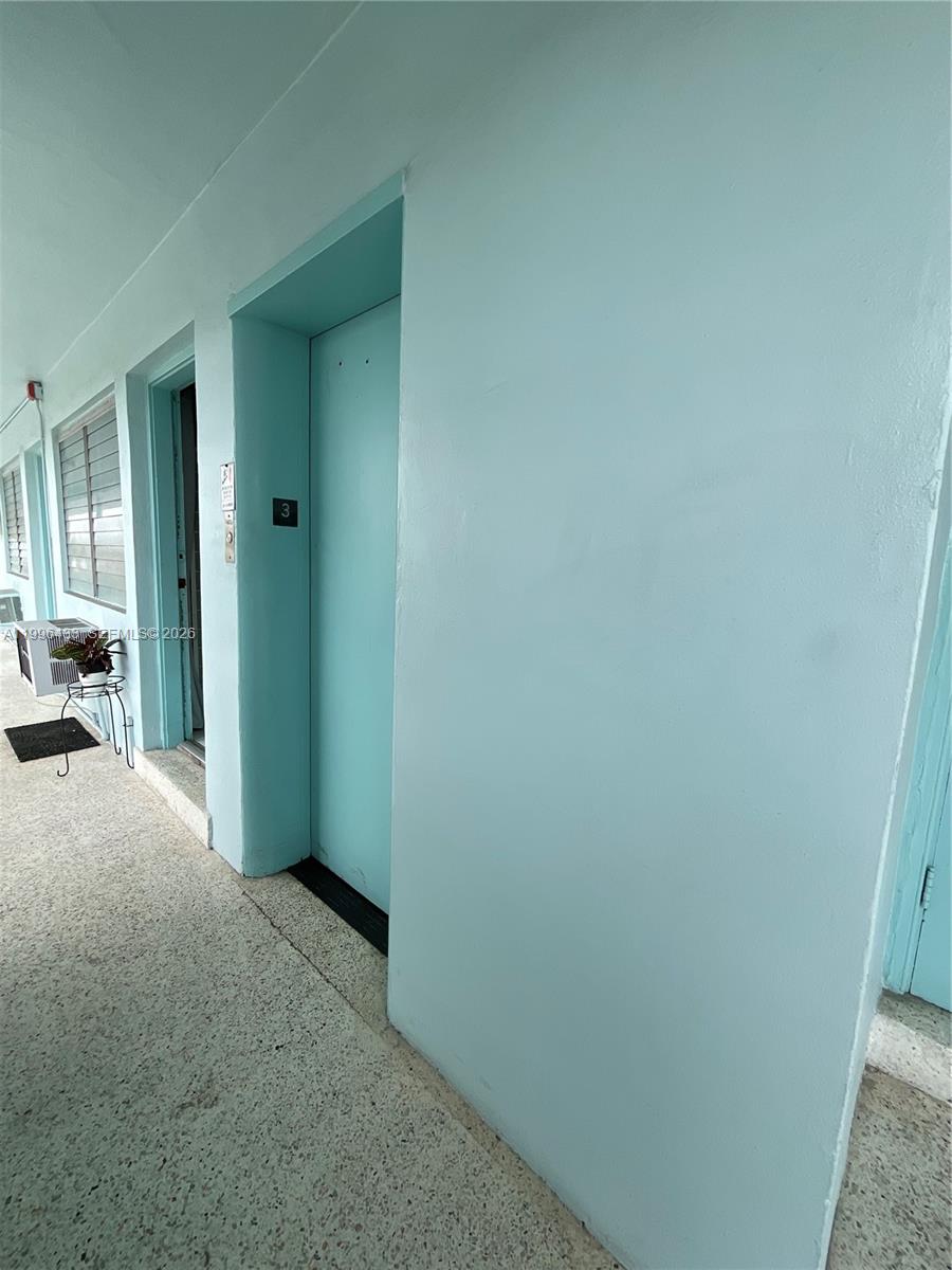 An exterior walkway leads to a light blue door marked with the number three — 1004 Pennsylvania Ave # 15, Miami Beach FL 33139, MIAMI BEACH, FL