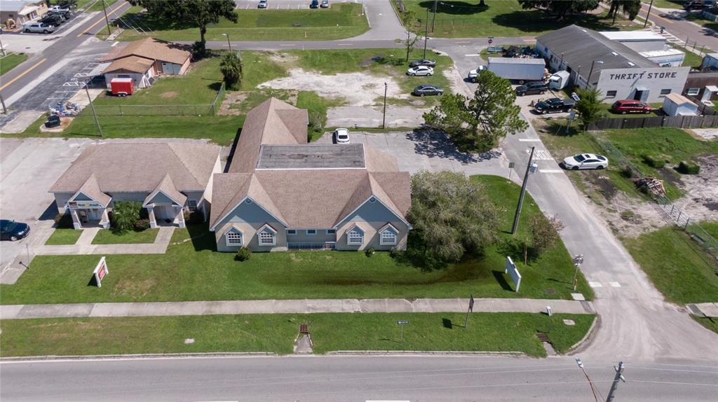 An aerial view shows a tan commercial building with a brown roof and surrounding parking — 504 E BAKER STREET, PLANT CITY, FL
