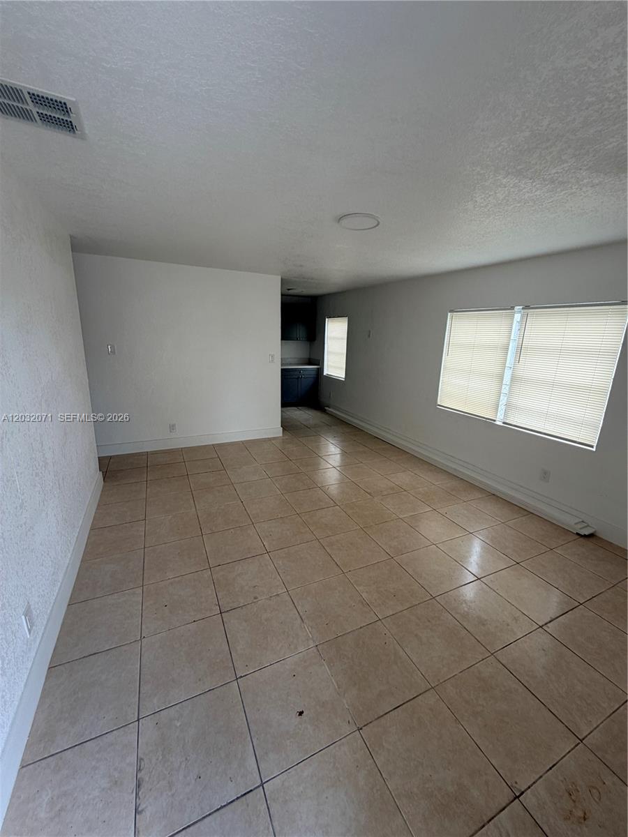 An empty room features beige tile flooring, white walls, and two windows with blinds — 753 SW 3rd Pl # 753, Dania Beach FL 33004, DANIA BEACH, FL