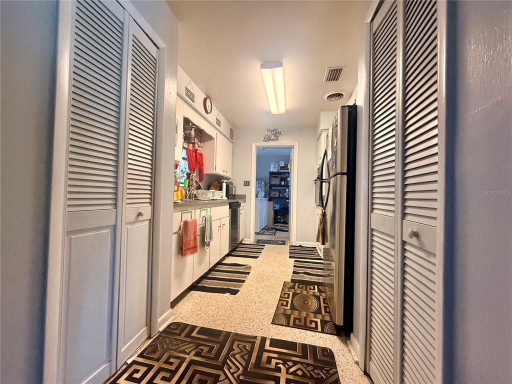 A room with brown walls, a ceiling fan, and a doorway leading to another room — 611 RIDGEFIELD AVENUE, OCOEE, FL