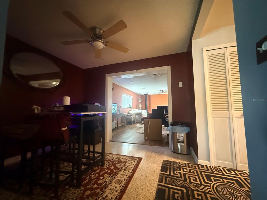 A spacious room with light blue walls, white trim, and speckled terrazzo flooring — 611 RIDGEFIELD AVENUE, OCOEE, FL