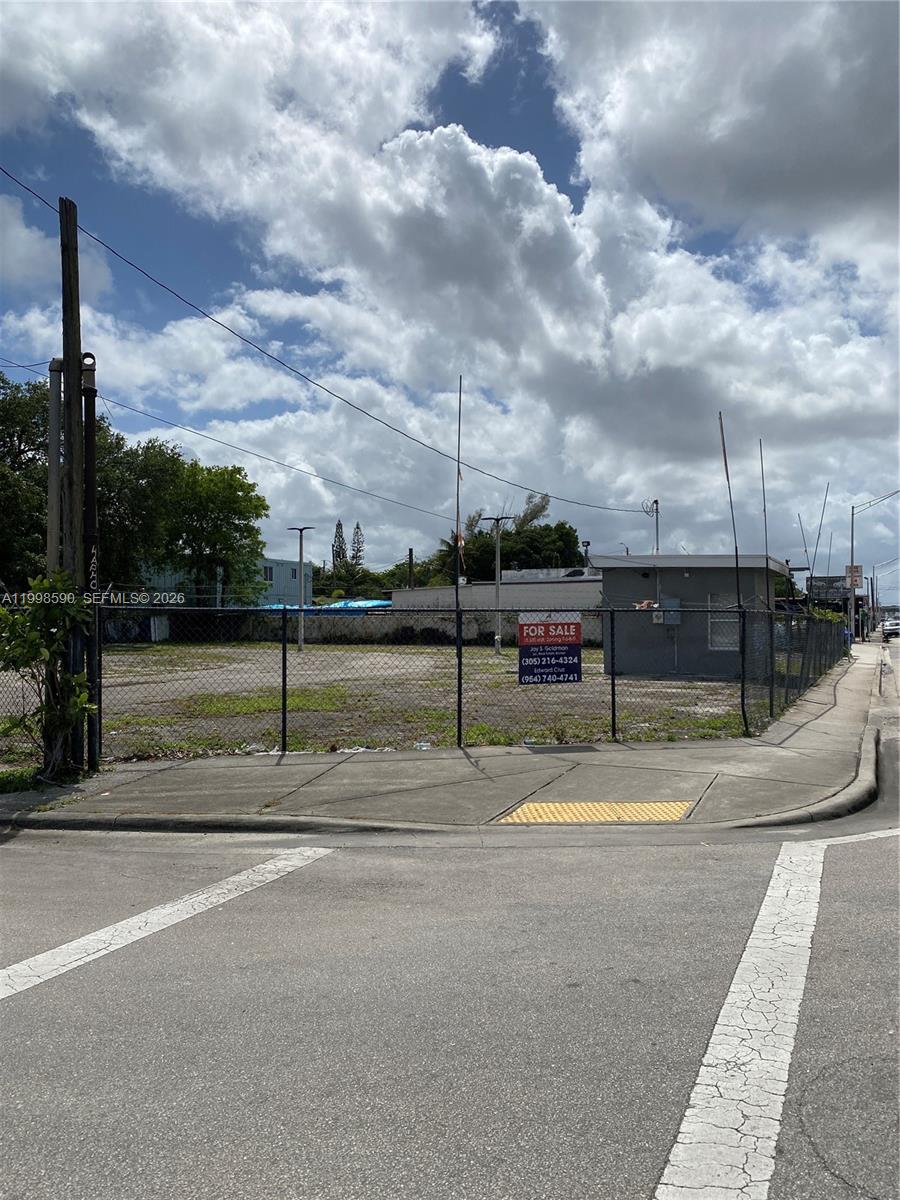 A fenced, vacant lot with a small building stands at a street corner — 300 NW 79th St, Miami FL 33150, MIAMI, FL