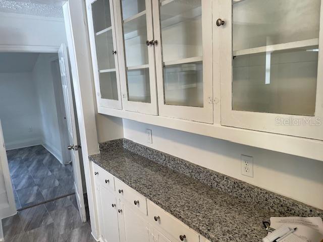 A kitchen features white glass-front cabinets, a granite countertop, and a doorway to another room — 221 W EMILY STREET, TAMPA, FL