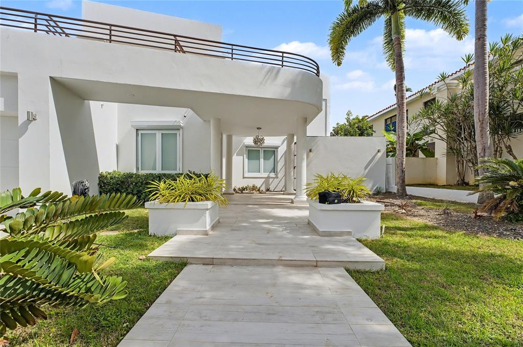 A white modern house features a covered entryway with columns and a second-story balcony — 2A GIGI STREET, URB.SANTA MARIA, SAN JUAN, PR