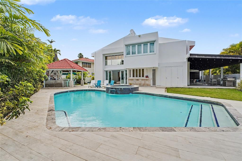 A white two-story house features a swimming pool with a spa and a covered patio — 2A GIGI STREET, URB.SANTA MARIA, SAN JUAN, PR