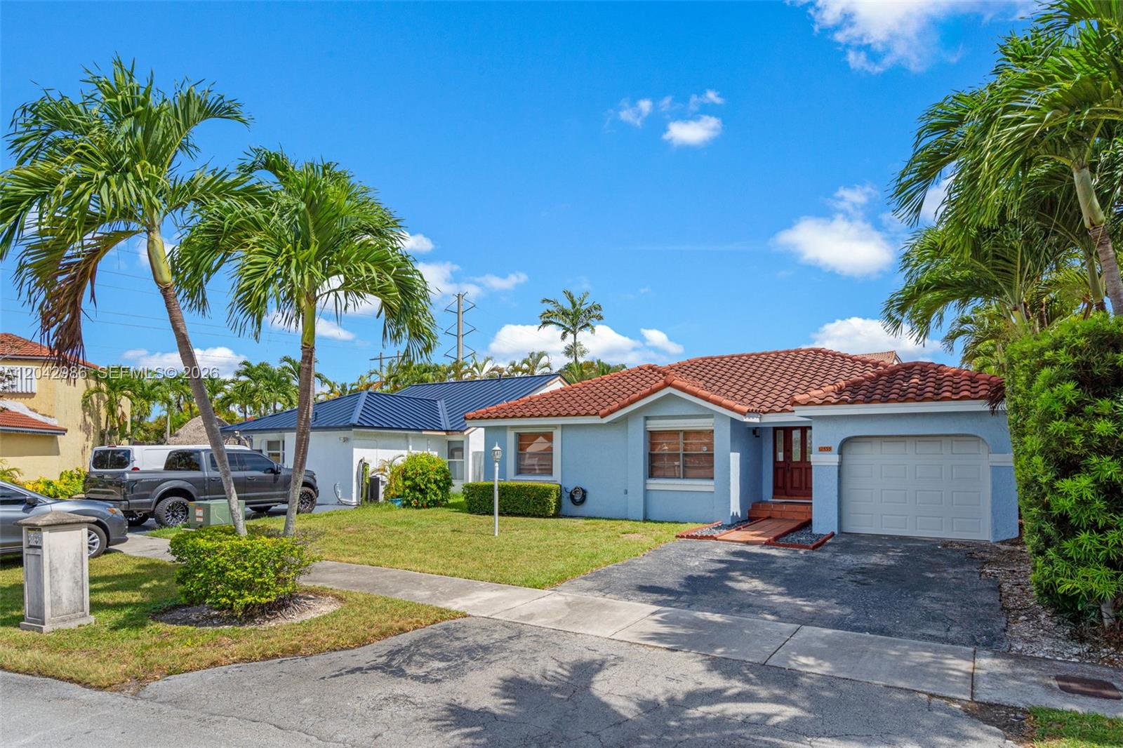 A light blue single-story house with a red tile roof and a front-facing garage — 12535 SW 95th Ter, Miami FL 33186, MIAMI, FL