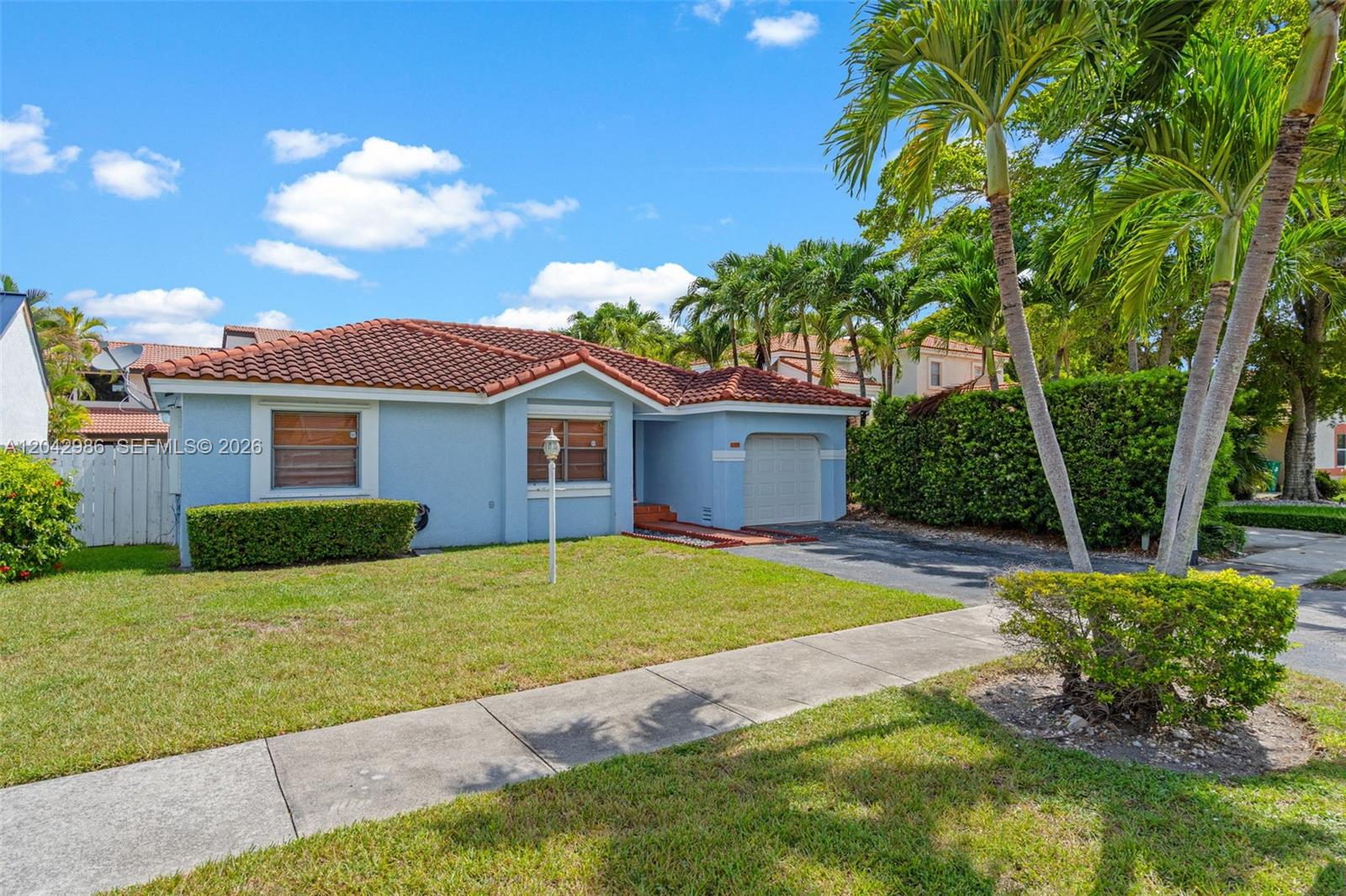 A light blue single-story house with a red tile roof and a front-facing garage — 12535 SW 95th Ter, Miami FL 33186, MIAMI, FL
