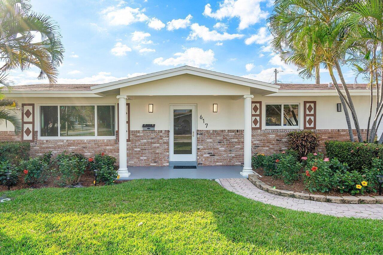 A single-story house with a brick facade, white columns, and a paved walkway — 617 SE 8th Avenue, Deerfield Beach FL 33441, DEERFIELD BEACH, FL