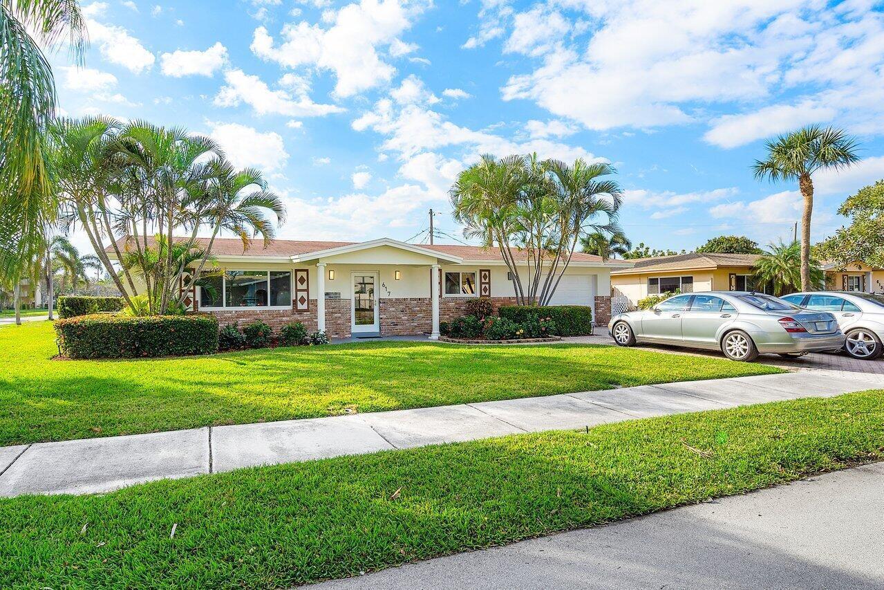 A single-story brick house with a front lawn, palm trees, and a paved driveway — 617 SE 8th Avenue, Deerfield Beach FL 33441, DEERFIELD BEACH, FL