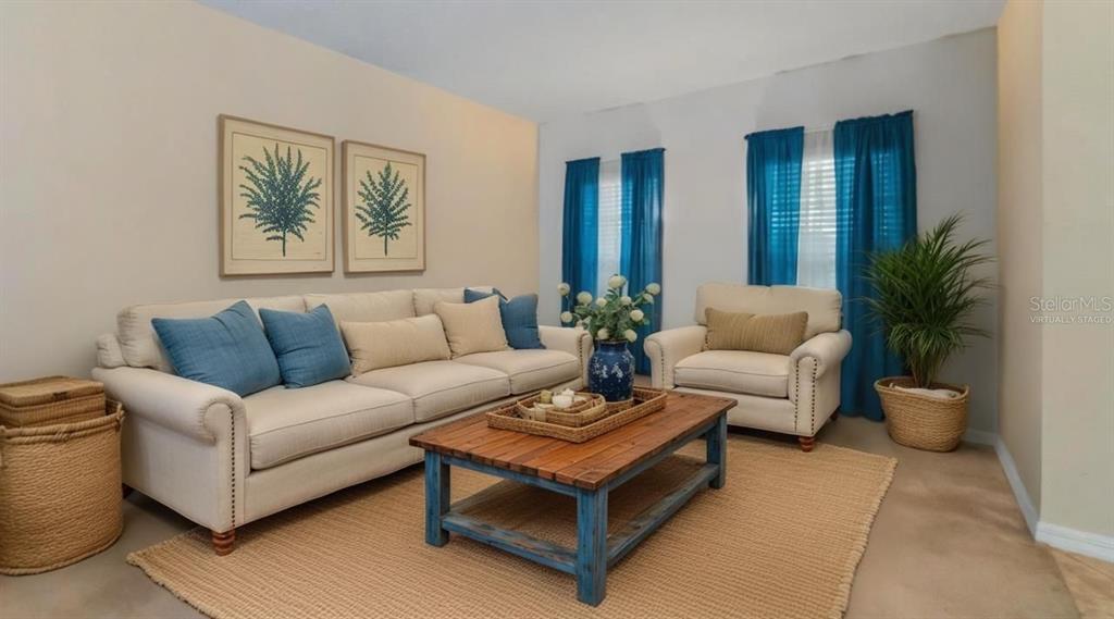 A living room features a beige sofa and armchair, a wooden coffee table, and blue curtains — 219 BELLA WAY, GROVELAND, FL