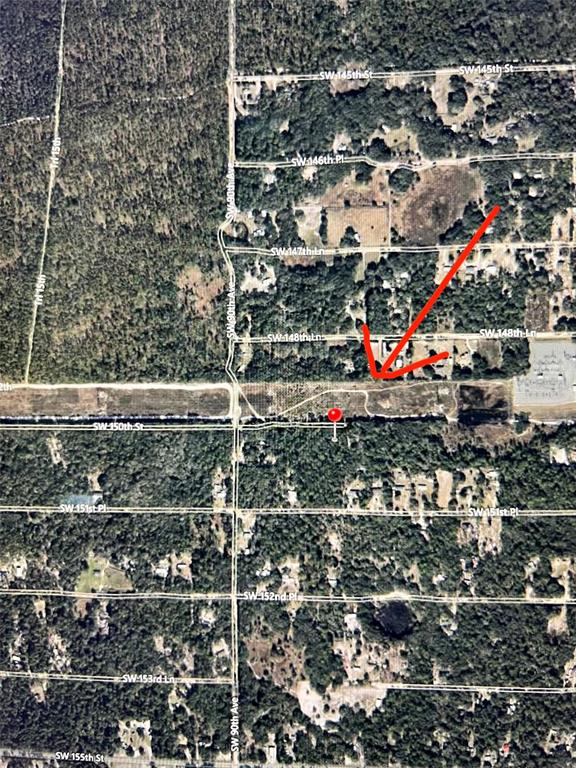 This is an aerial map view showing a red arrow pointing toward a specific land parcel — SW 150TH STREET, DUNNELLON, FL