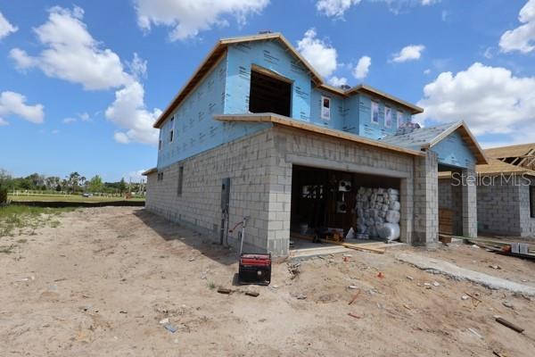 A two-story house under construction with concrete block walls and blue sheathing — 11804 FULL MOON LOOP, PARRISH, FL