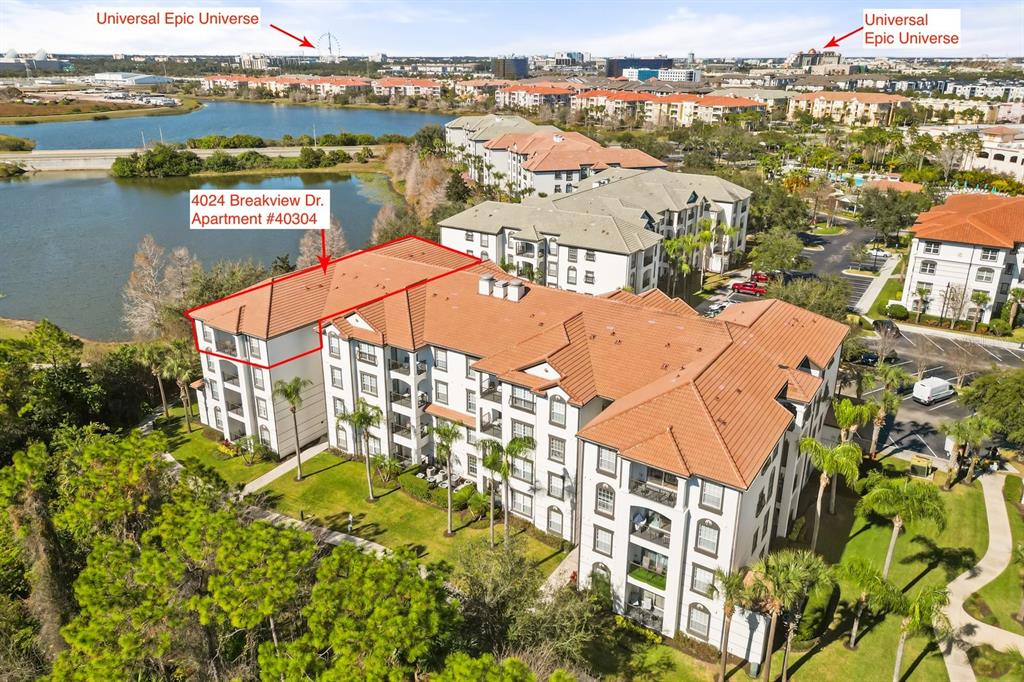 An aerial view shows a multi-story apartment building with a red tile roof near water — 4024 BREAKVIEW DRIVE UNIT 40304, ORLANDO, FL