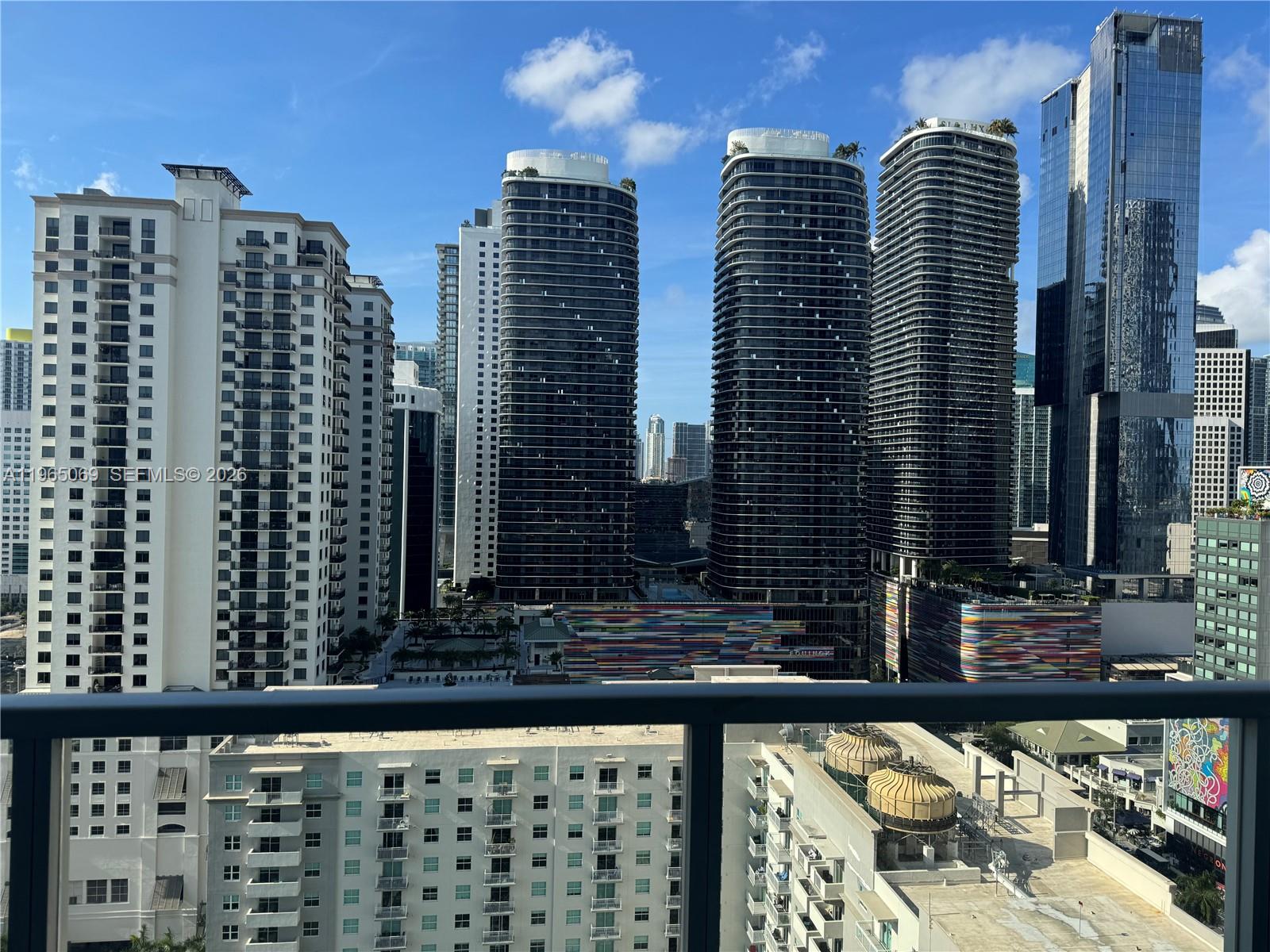 A high-angle view of a dense urban skyline featuring multiple modern glass skyscrapers — 1111 SW 1st Ave, Miami FL 33130, MIAMI, FL