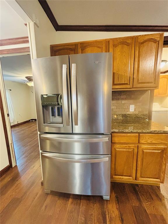 A stainless steel French door refrigerator stands in a kitchen with oak cabinets and countertops — 34445 COUNTRYSIDE DRIVE, WESLEY CHAPEL, FL