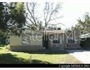 A single-story house with a light-colored exterior, a front porch, and a large tree — 1014 37TH STREET, ORLANDO, FL