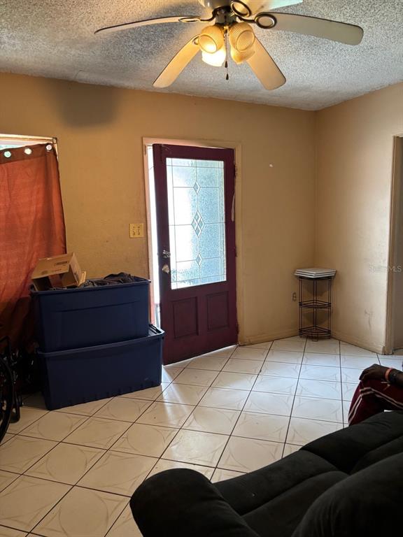 A room with tiled floors, a ceiling fan, and a door with a glass insert — 1014 37TH STREET, ORLANDO, FL