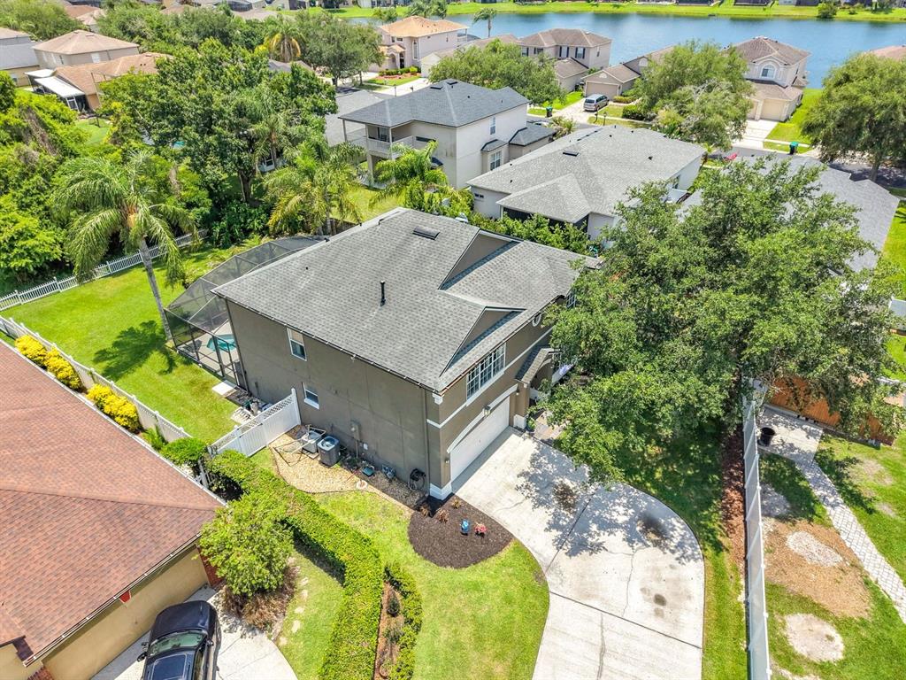 An aerial view shows a two-story house with a pool enclosure and a concrete driveway — 14664 SAINT GEORGES HILL DRIVE, ORLANDO, FL