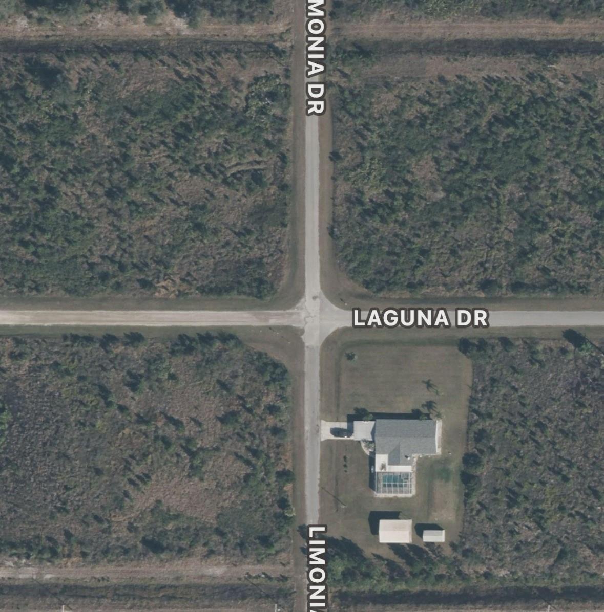 This aerial view shows a residential property at the intersection of two dirt roads — 7 Laguna Drive, FL 33855, FL