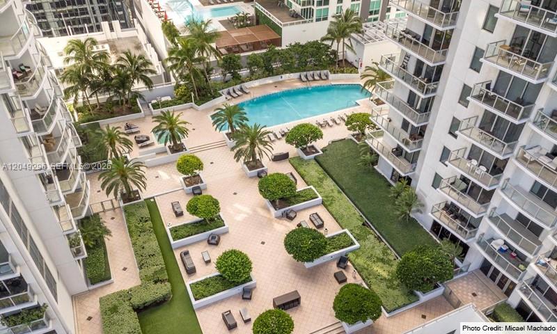 An aerial view of a residential building courtyard featuring a swimming pool and landscaped patio — 1060 Brickell Ave # 1505, Miami FL 33131, MIAMI, FL