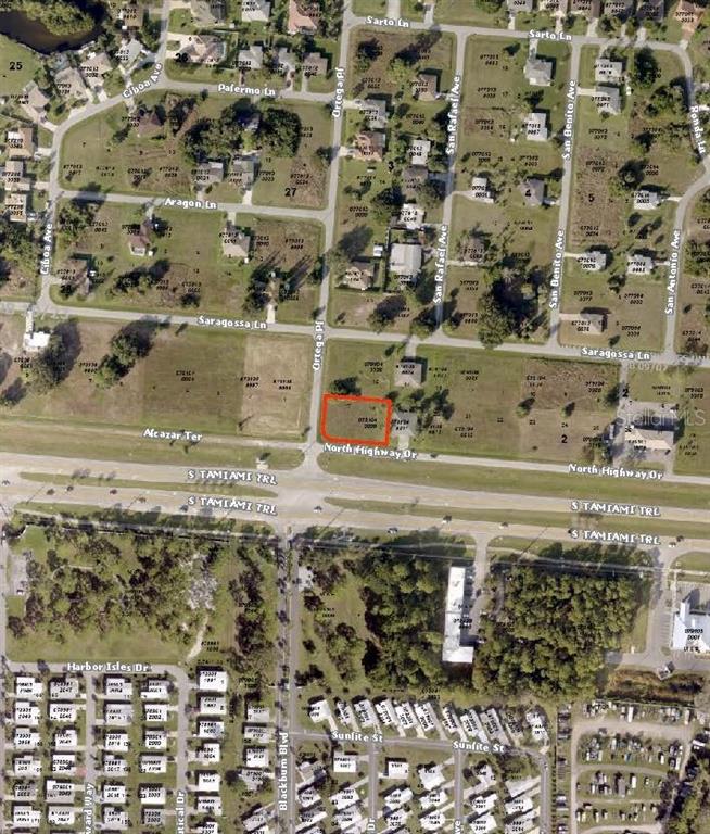 This is an aerial map showing a highlighted vacant lot near a major highway intersection — 12000 S TAMIAMI LOT 17 &18 TRAIL UNIT Front, NORTH PORT, FL
