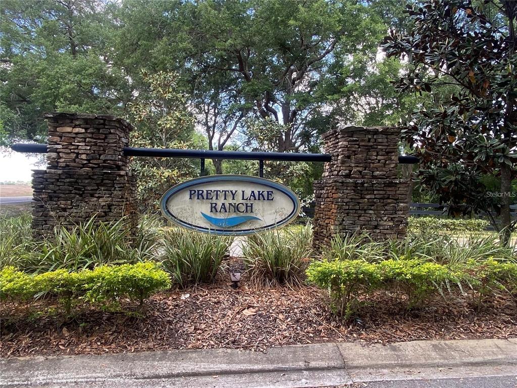 A stone monument sign for Pretty Lake Ranch sits in a landscaped garden area — 9070 STATE ROAD 33, GROVELAND, FL