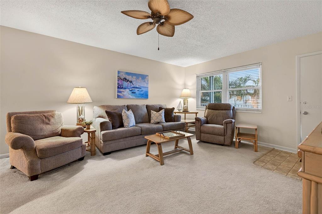 A living room features a sofa, two armchairs, a coffee table, and a ceiling fan — 5267 81ST STREET N UNIT 18, ST PETERSBURG, FL